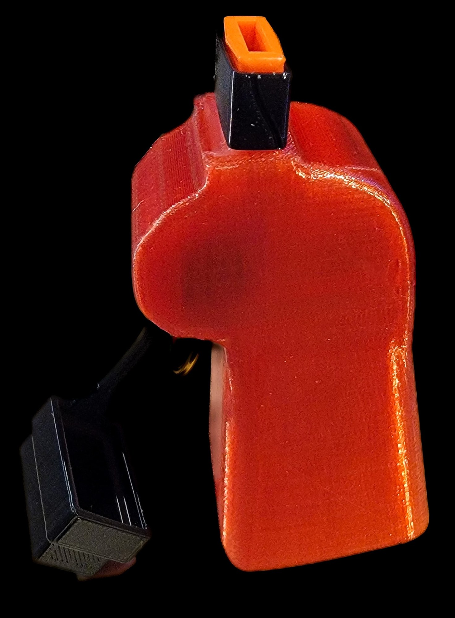 An orange and black 3D-printed object resembling a trigger or handle, with a small rectangular base attached to a wire.